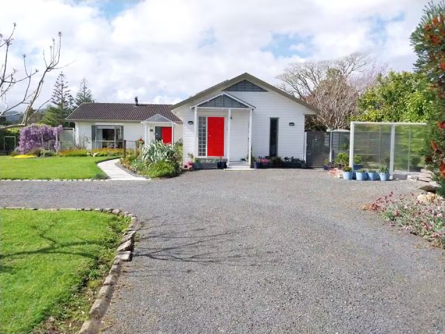Approaching the Red Door Guest Suite in spring, from the road
